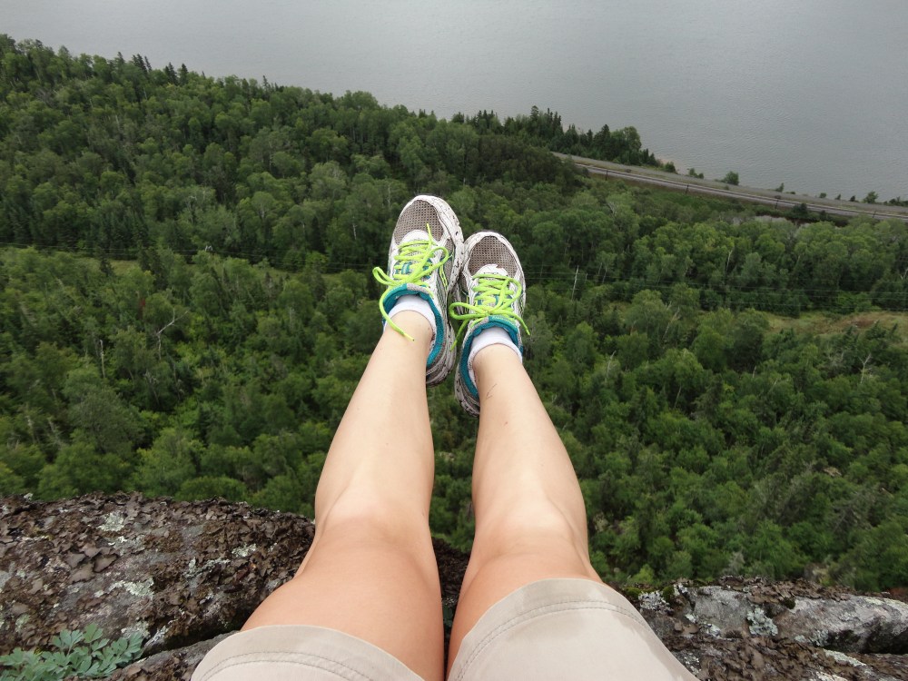 Legs out over the cliff side. 